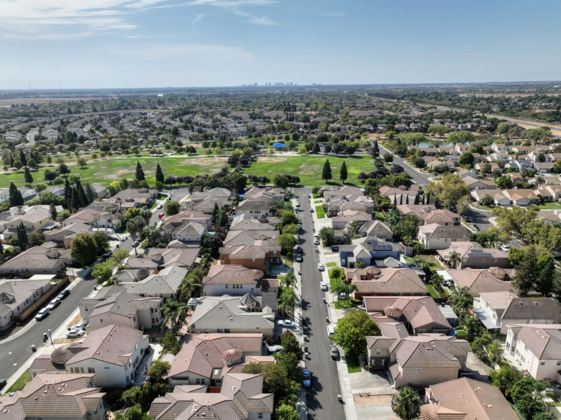 Aerial view of a suburban subdivision of composite shingle roofs
